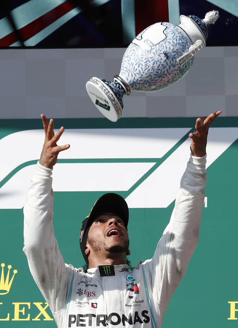 Mercedes driver Lewis Hamilton of Britain celebrates on the podium after winning the Hungarian ...