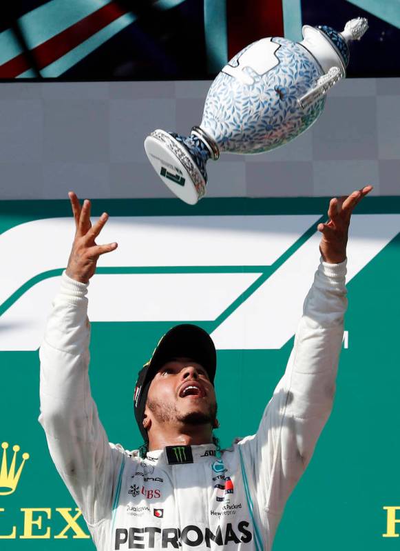 Mercedes driver Lewis Hamilton of Britain celebrates on the podium after winning the Hungarian ...