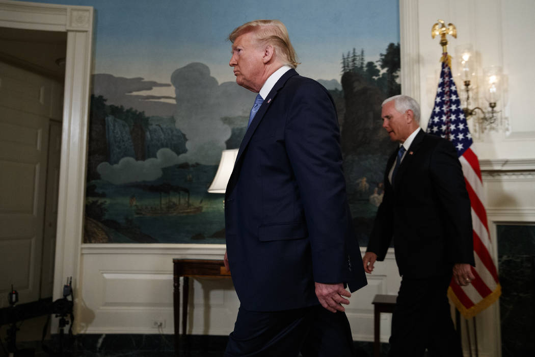 Vice President Mike Pence follows President Donald Trump as he walks off after speaking about t ...