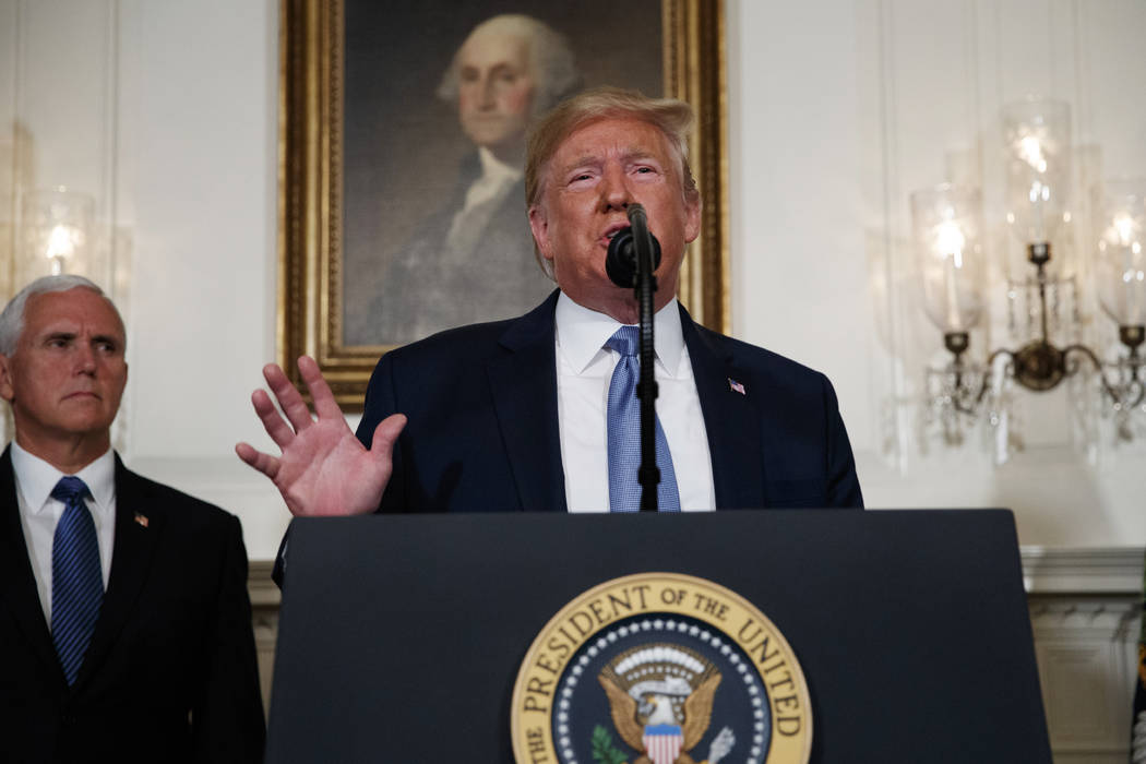 Vice President Mike Pence listens as President Donald Trump speaks about the mass shootings in ...