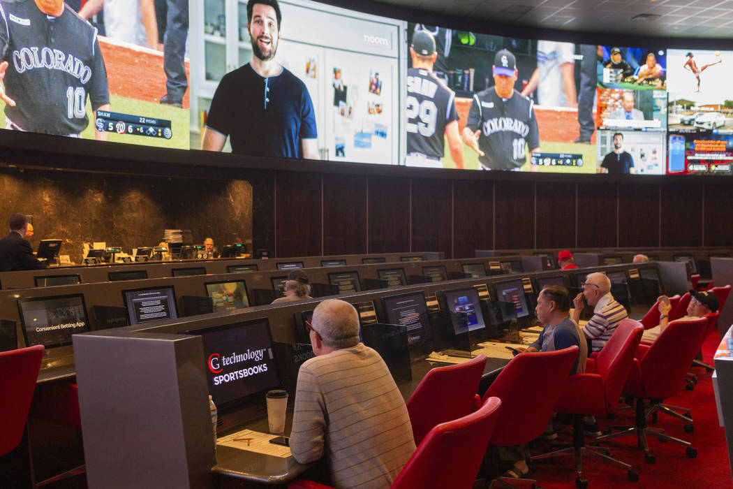 Betters watch live sports at the CG Technology sports book at the newly renovated Palms in Las ...