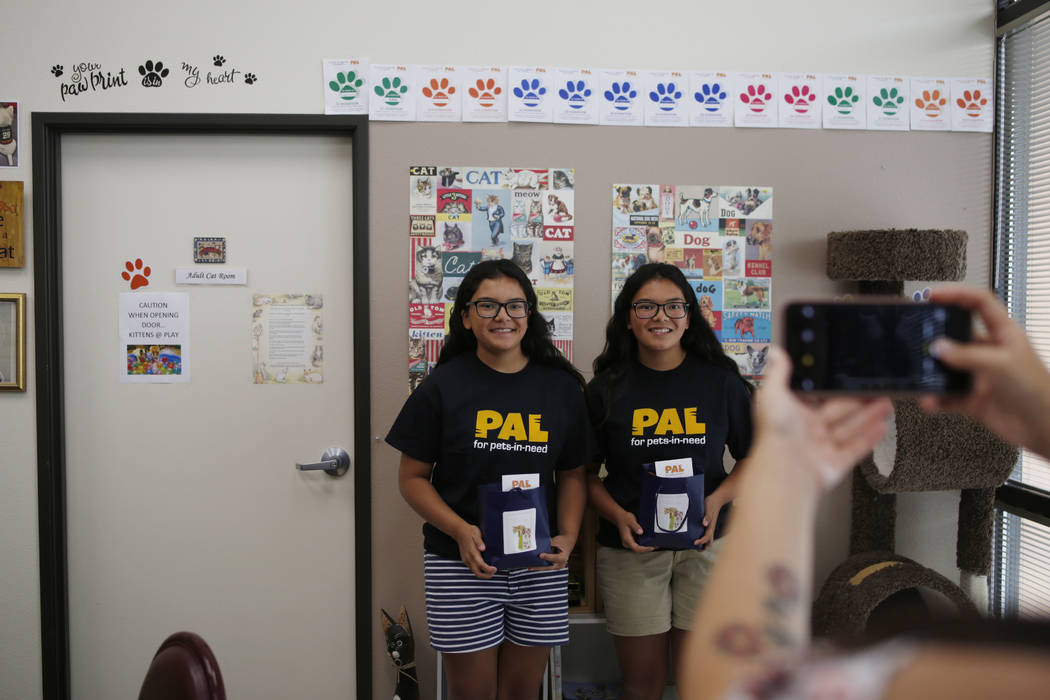 Anaisa, left, and Malena Maestas, 13, get their photo taken during the soft launch at the Rescu ...