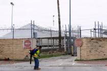 A man uses a leaf blower to clean the sidewalk Thursday, July 25, 2019, outside tent facilities ...