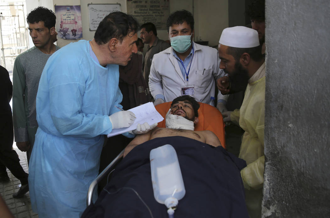 A wounded man receives treatment at a hospital after an explosion in Kabul, Afghanistan, Wednes ...