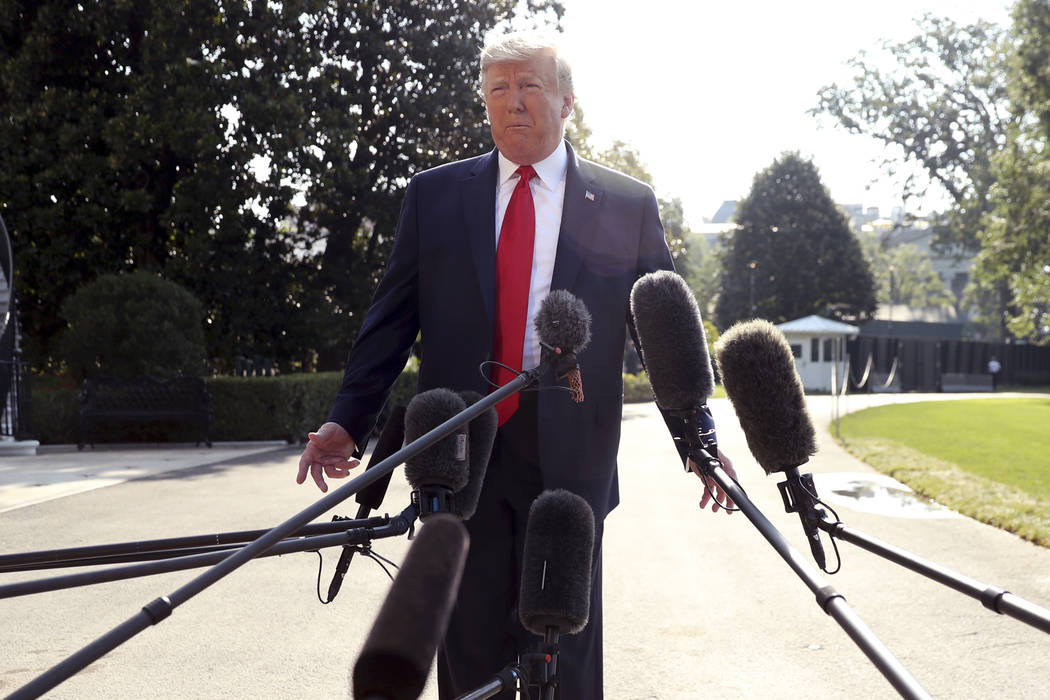 President Donald Trump talks to the press before walking across the South Lawn of the White Hou ...