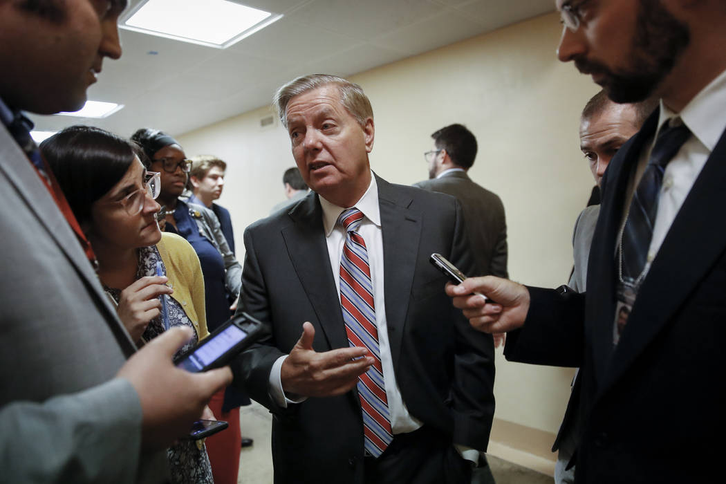 Senate Judiciary Committee Chairman Lindsey Graham, R-S.C., talks to reporters on his way to th ...