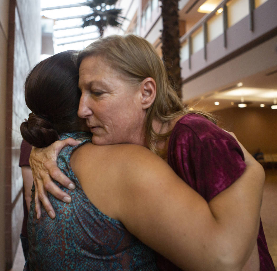 Jamie Minkler, right, hugs Misty Manuel at the Regional Justice Center on Wednesday, Aug. 7, 20 ...