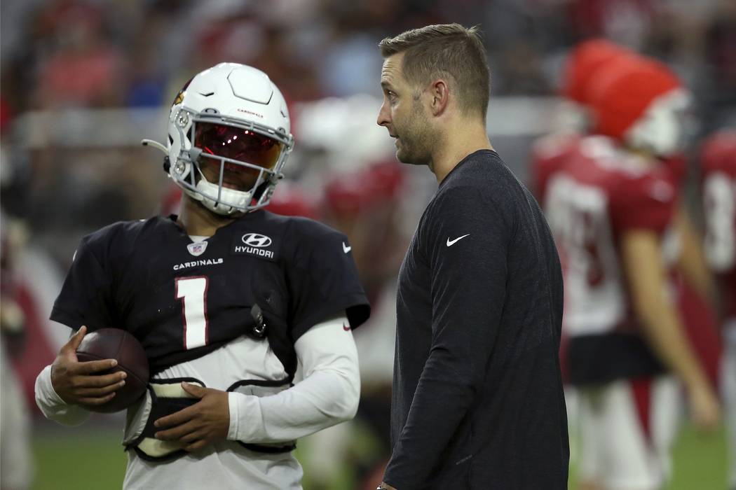 Arizona Cardinals head coach Kliff Kingsbury, right, talks with rookie quarterback Kyler Murray ...