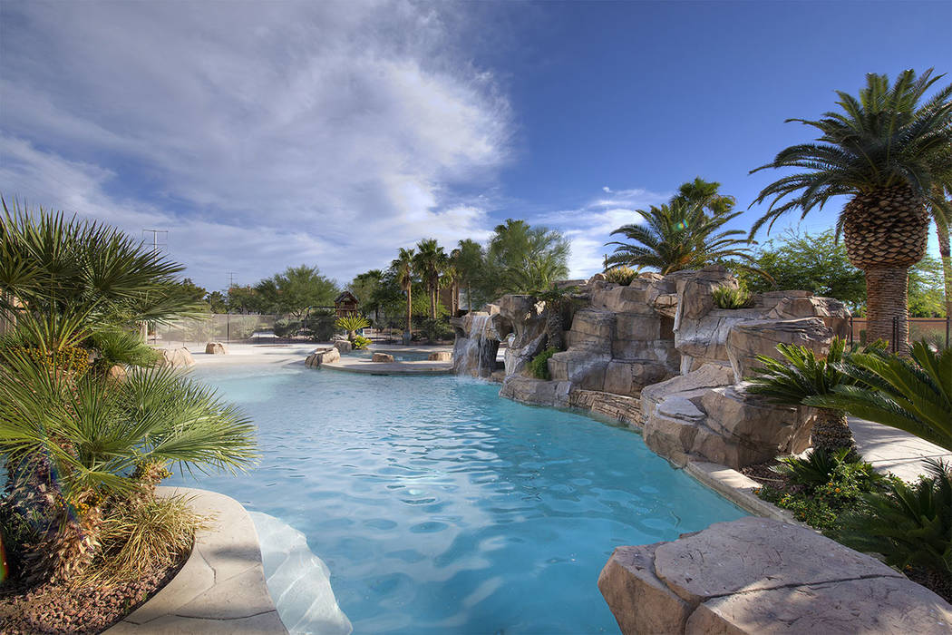 The pool has waterfalls. (Synergy|Sotheby’s International Realty)