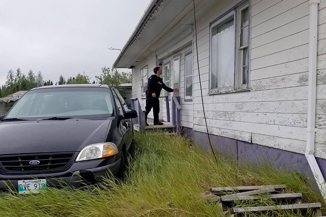 In this recent photo provided by the Royal Canadian Mounted Police, RCMP officers canvas homes ...