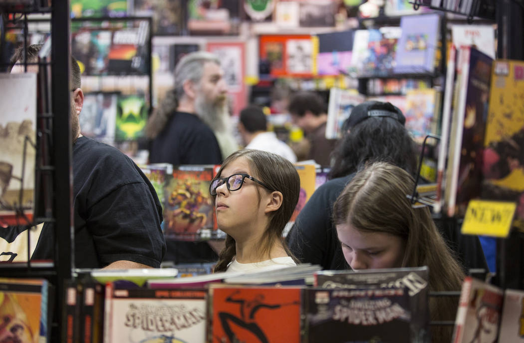 Shoppers peruse the aisles at Alternate Reality Comics during free comic book day on May, 5, 20 ...