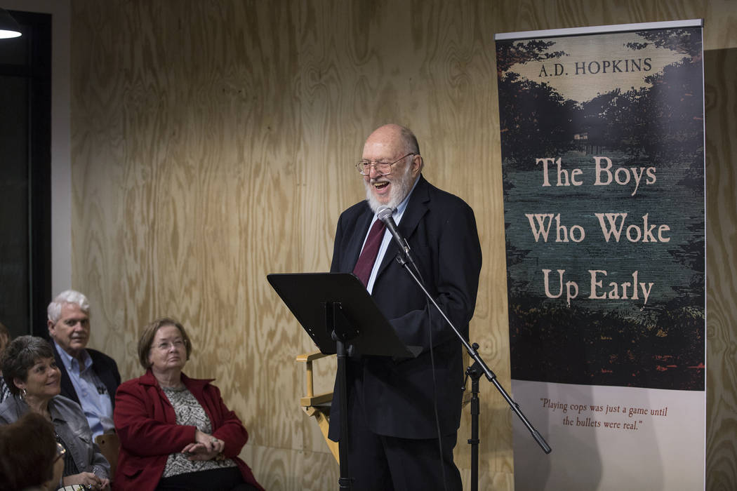 Author A.D. Hopkins reads from his novel, "The Boys Who Woke Up Early," during a book release p ...
