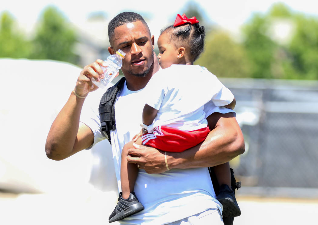 Oakland Raiders safety Johnathan Abram carries his daughter Harlee, 2, after a joint NFL traini ...