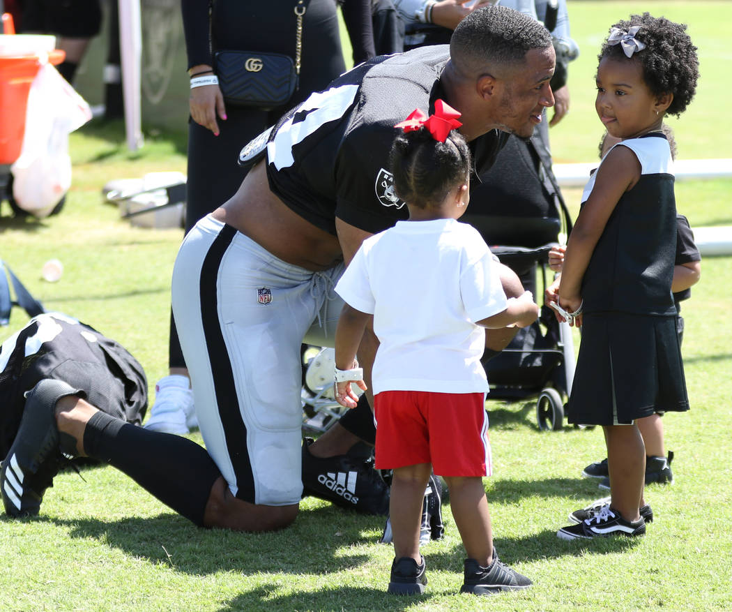 Oakland Raiders safety Johnathan Abram (24) introduces his 2-year-old daughter Harlee, center, ...