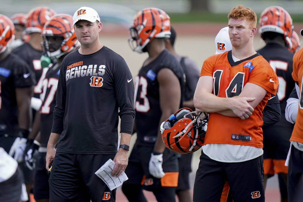 Cincinnati Bengals head coach Zac Taylor and quarterback Andy Dalton (14) watch practice during ...