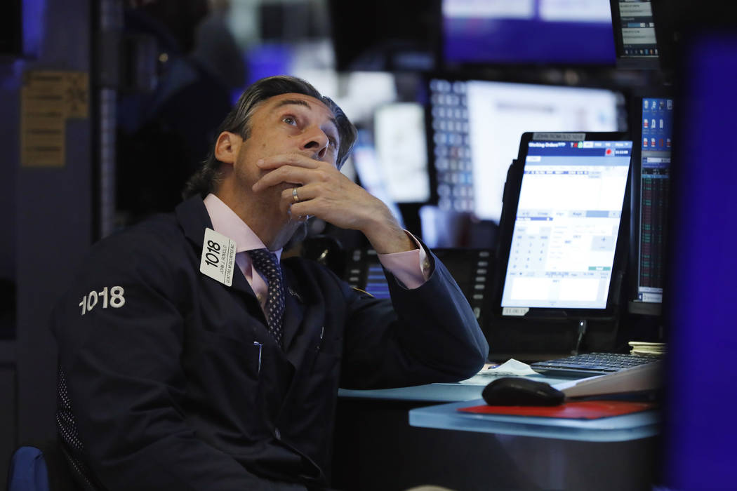 Trader John Romolo works on the floor of the New York Stock Exchange, Wednesday, Aug. 7, 2019. ...