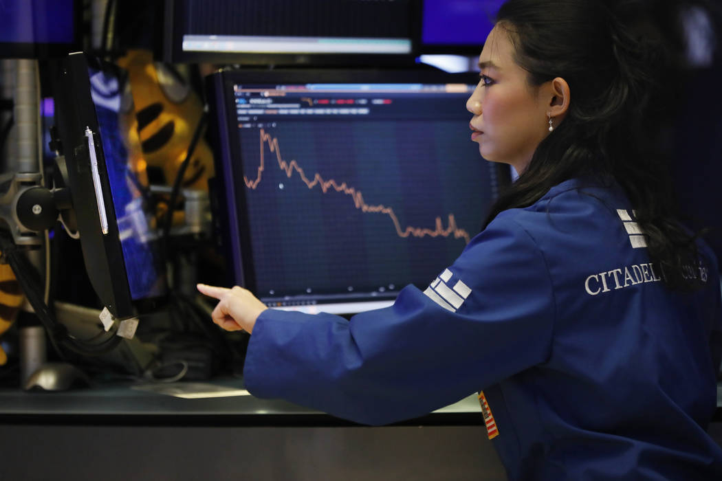 Specialist Lingbo Jiang works on the floor of the New York Stock Exchange, Wednesday, Aug. 7, 2 ...