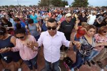 In this Aug. 4, 2019, file photo, people join hands and pray during the Hope Border Institute p ...