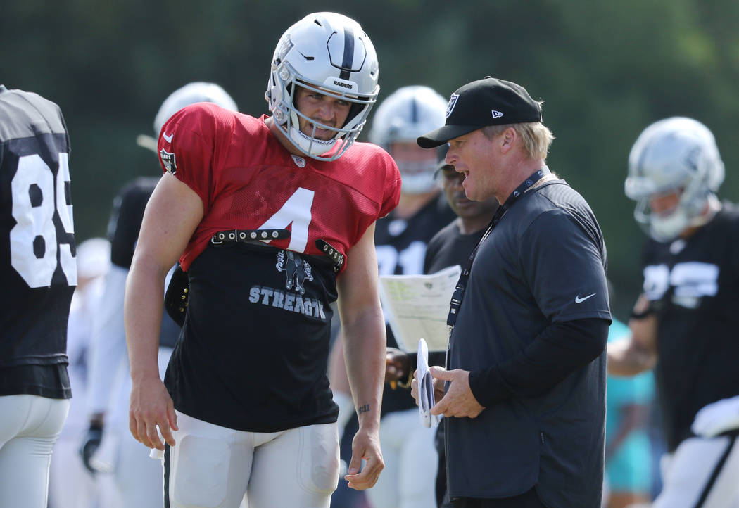 Oakland Raiders quarterback Derek Carr (4) and head coach Jon Gruden have a conversation after ...