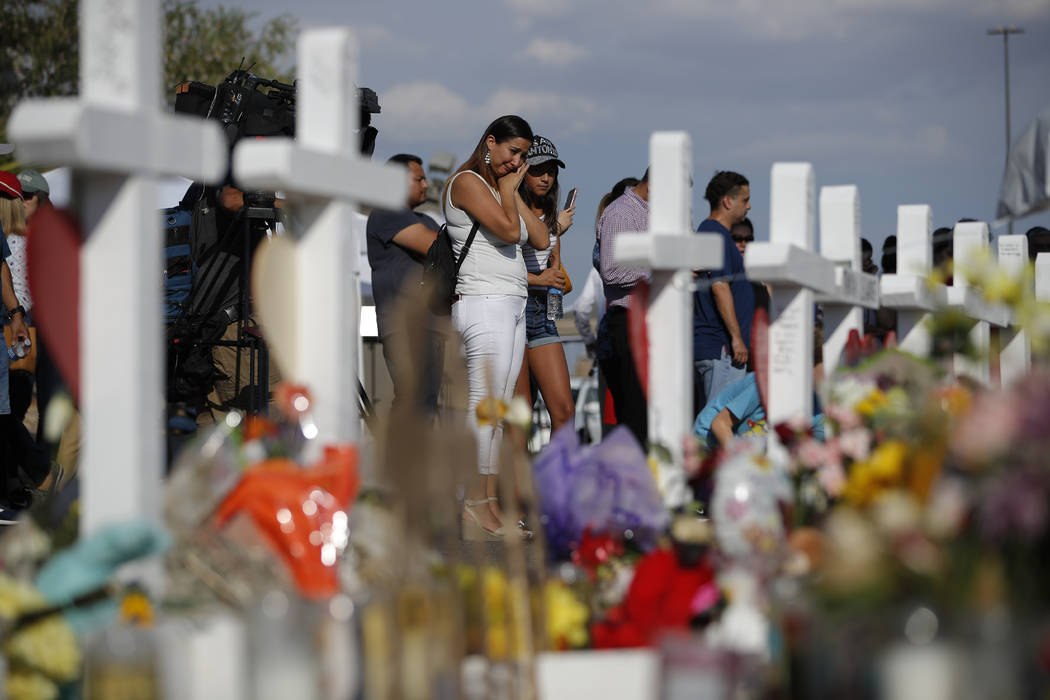 People visit a makeshift memorial, Monday, Aug. 5, 2019, at the site of a mass shooting at a sh ...