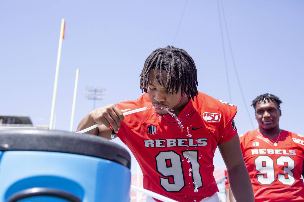 UNLV's defensive lineman Nate Neal (91) drinks water during the team's photo day at Sam Boyd St ...