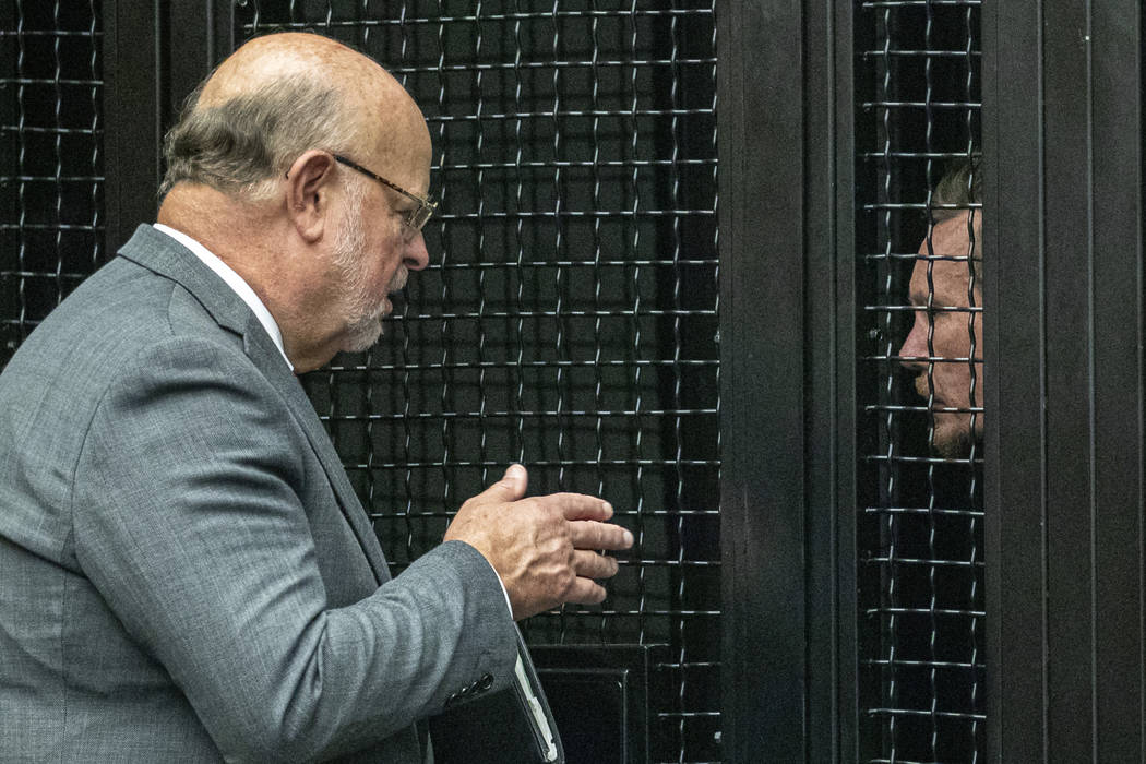 Defense attorney Robert Sanger, left, talks to Peter Chadwick, who is charged with killing his ...