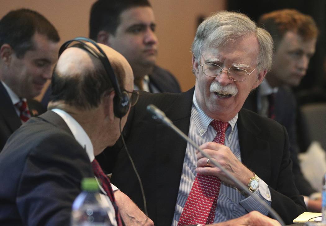 U.S. National security adviser John Bolton, right, speaks with U.S. Commerce Secretary Wilbur R ...