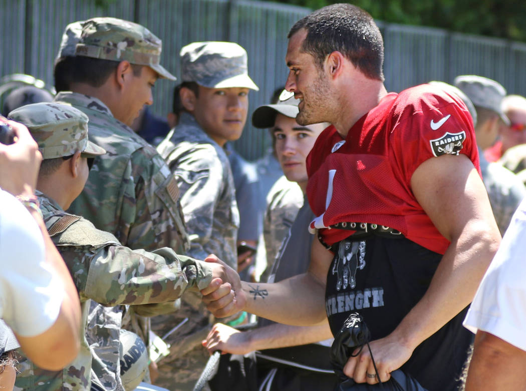 Oakland Raiders quarterback Derek Carr (4) meets and greets members of the Air Force after the ...