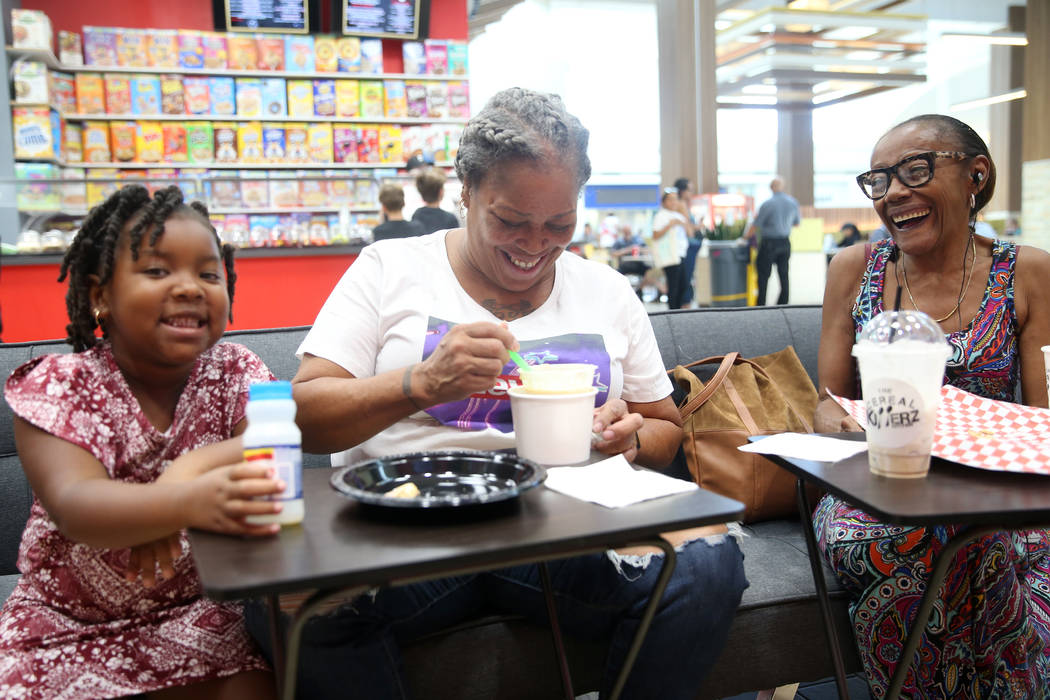 Victoria Smith-Ashby, center, her granddaughter DemiRose Trim, 5, left, and friend Barbara Flet ...