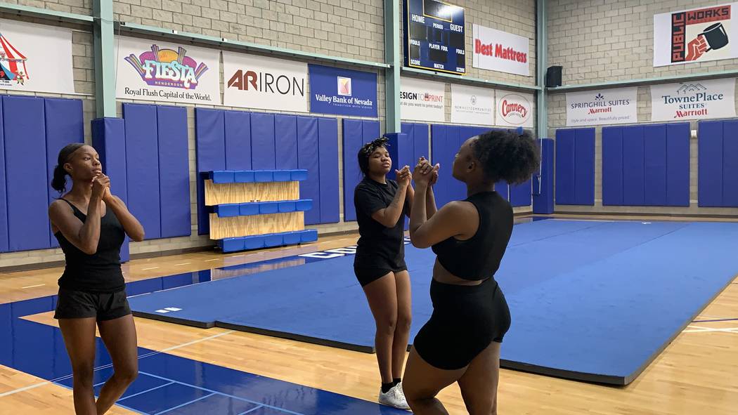Jhailen Moorer-Johnson, right, teaches practices a cheer routine with her teammates during prac ...