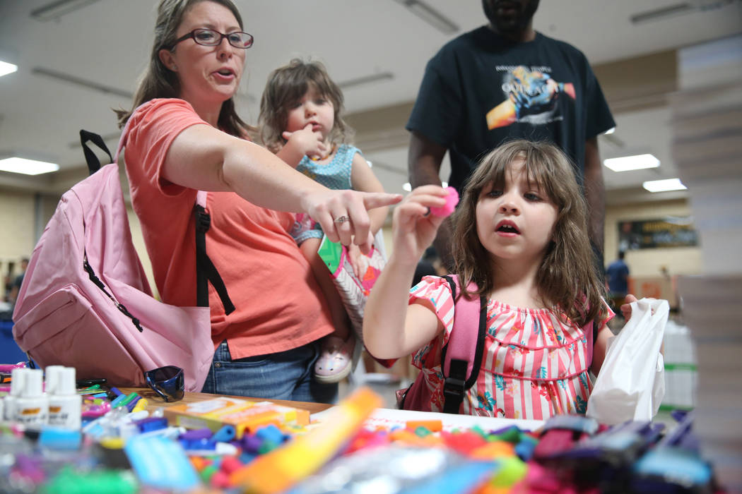 Angela D'Agostin, from left, holding her daughter Alena, 2, and with her daughter Anna, 5, sele ...