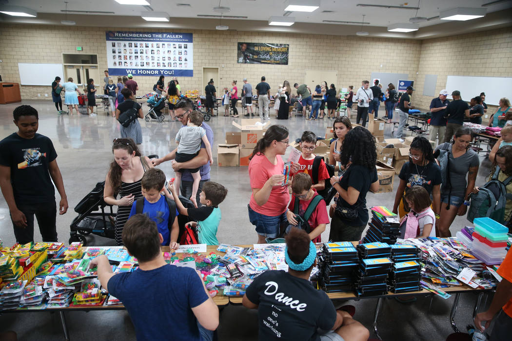 People attend an event for military families hosted by Operation Homefront where they received ...