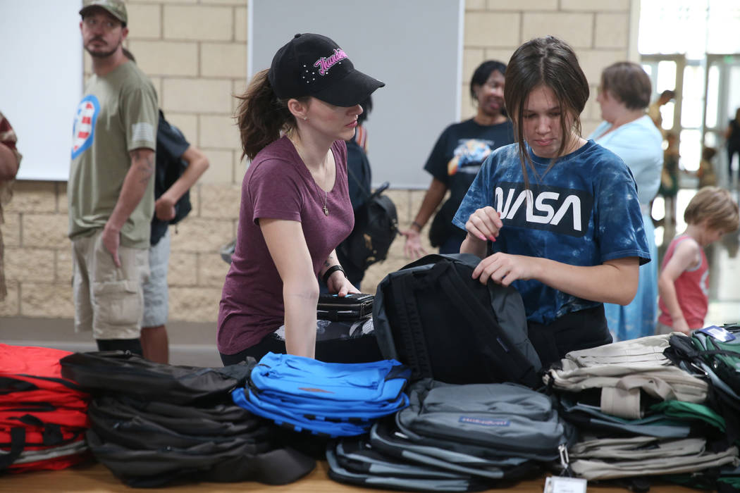 Taresa Olson, left, and her daughter Cambria, 12, select free school supplies during an event f ...