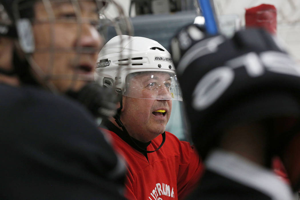 Players Arthur Wong, left, and Glenn Burgess wait to go back onto the ice during Ronnie's Hock ...