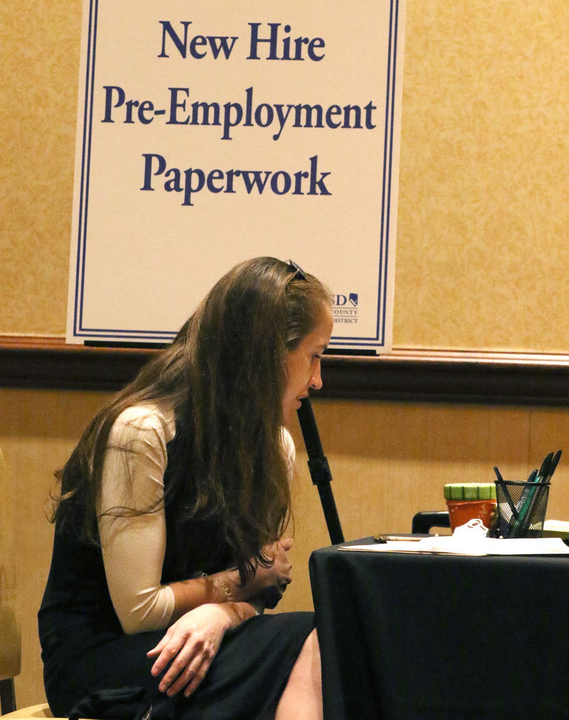 Ashley Robins, reviews documents during the Clark County School District new teacher hiring eve ...