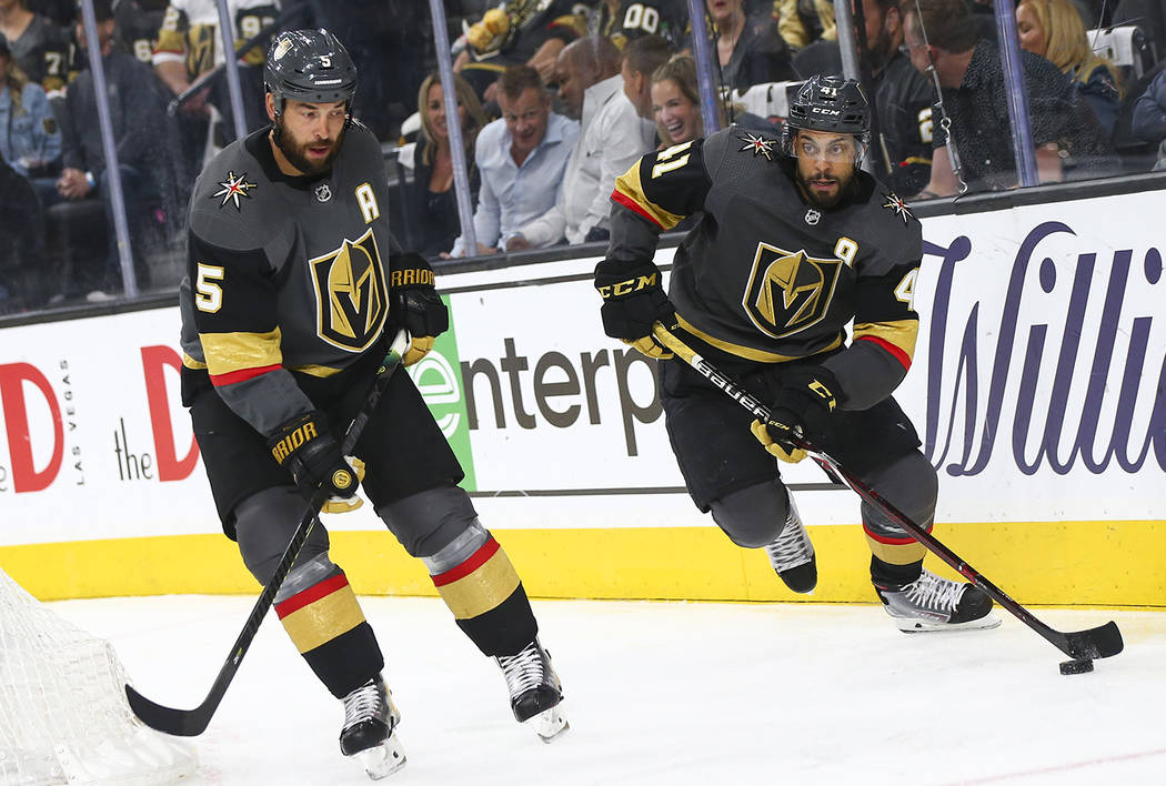 Golden Knights center Pierre-Edouard Bellemare (41) skates with the puck alongside defenseman D ...