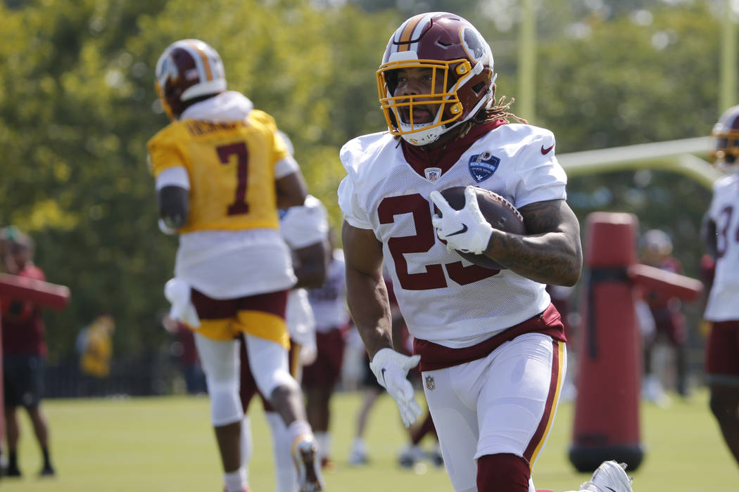 Washington Redskins running back Derrius Guice (29) runs a drill during the NFL football traini ...