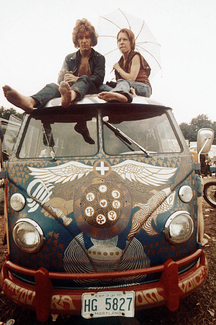 Concert-goers sit on the roof of a Volkswagen bus at the Woodstock Music and Arts Fair at Bethe ...