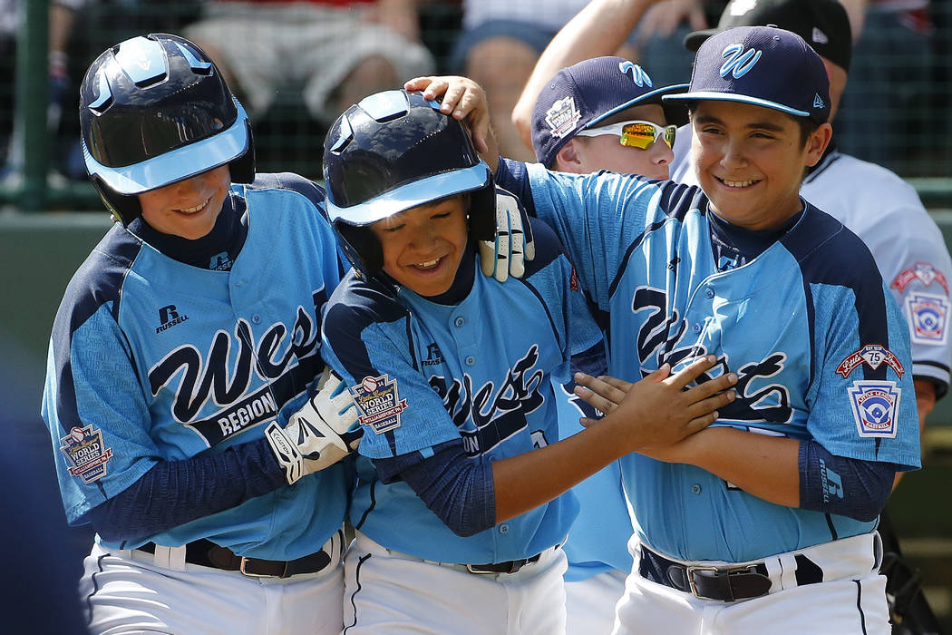 Las Vegas' Dominic Clayton, center, celebrates with teammates Josh Zuehlsdorff, left, and Dillo ...