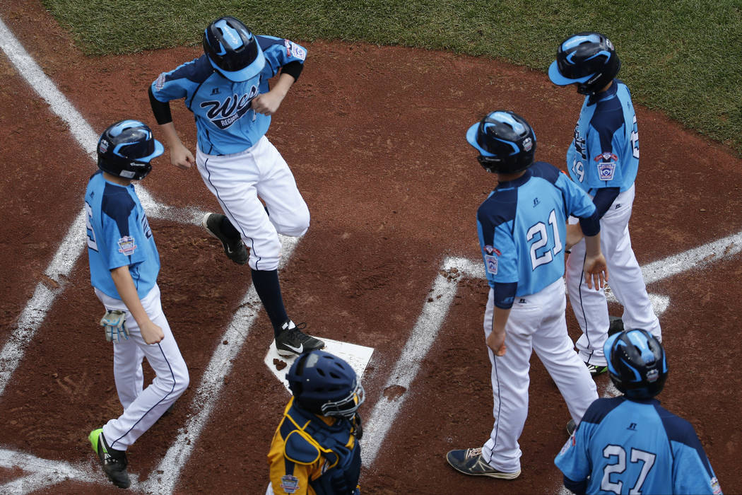 Las Vegas' Brad Stone, top left, crosses the plate after hitting a grand slam off Chicago pitch ...