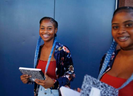 Sophomores Tashira, left, and Dashira McKay, 15, arrive on the first day of school at Liberty H ...