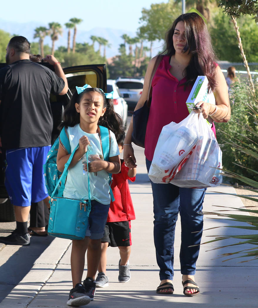 Natalia Rodriguez, 5, accompanied by her mother, Deborah, and her brother, Angel, arrives at Ro ...