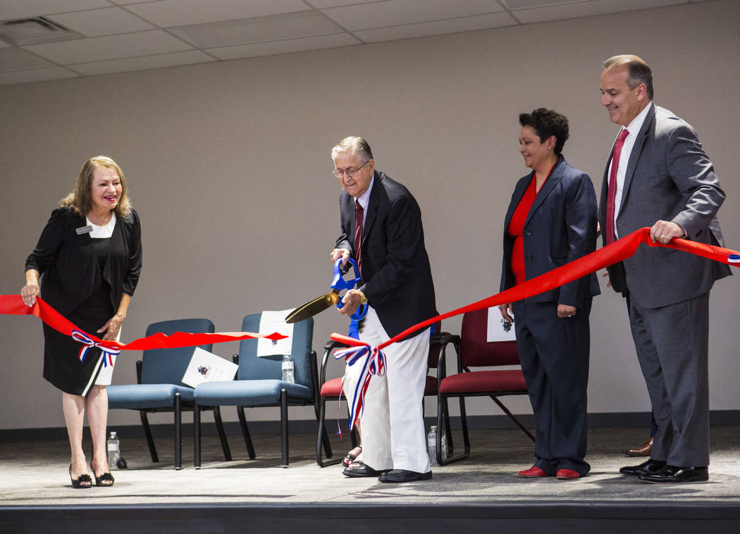Long-time educator Earl Jenkins, second from left, cuts the ribbon alongside, from left, Distri ...