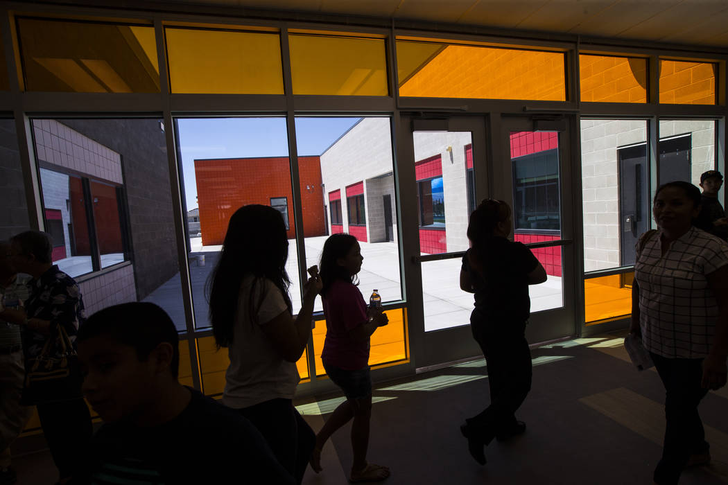 Families roam the hallways after a ribbon-cutting ceremony for Earl Jenkins Elementary School i ...