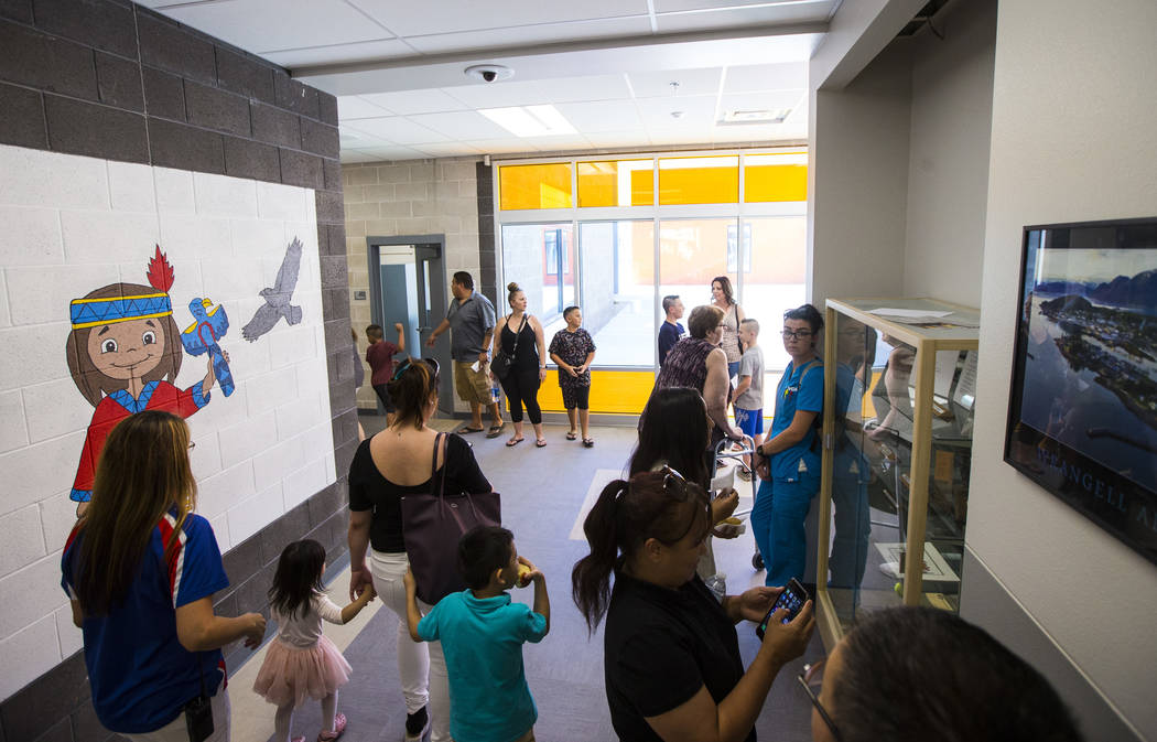 Families roam the hallways after a ribbon-cutting ceremony for Earl Jenkins Elementary School i ...