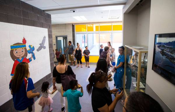 Families roam the hallways after a ribbon-cutting ceremony for Earl Jenkins Elementary School i ...