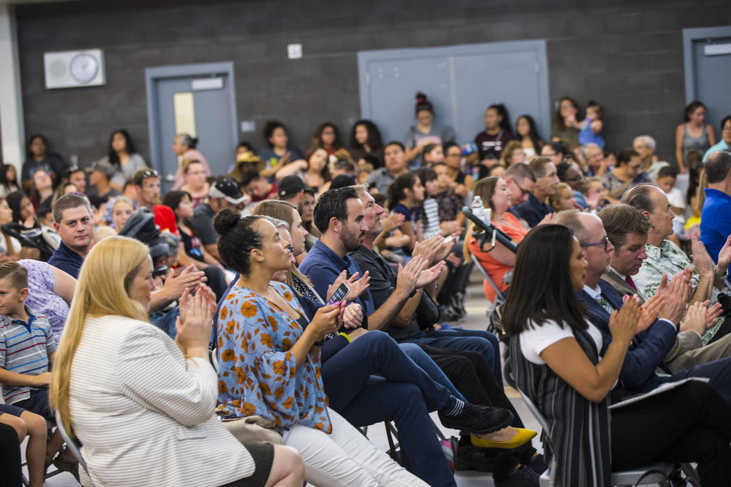 Attendees clap during a ribbon-cutting ceremony for Earl Jenkins Elementary School in east Las ...