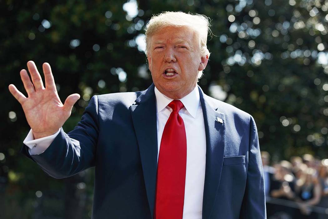 President Donald Trump talks to reporters on the South Lawn of the White House, Friday, Aug. 9, ...