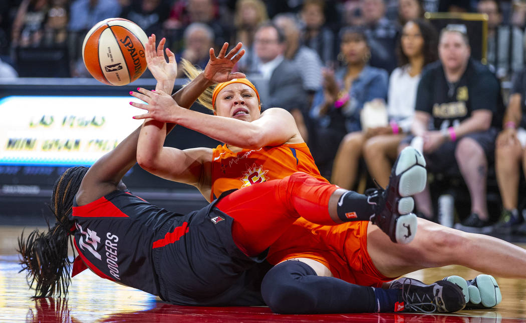 Las Vegas Aces guard Sugar Rodgers (14) rips the ball from Connecticut Sun guard Rachel Banham ...