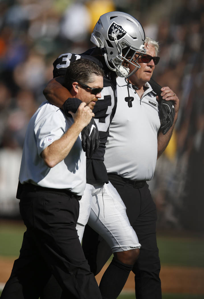 Oakland Raiders' Isaiah Johnson is assisted off the field during the first half of a preseason ...